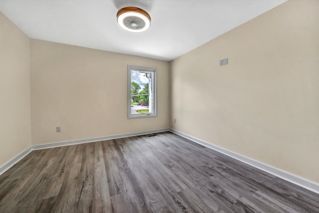 spare room featuring dark wood-type flooring