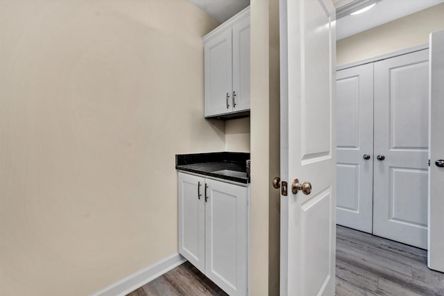 interior space with white cabinetry and light wood-type flooring