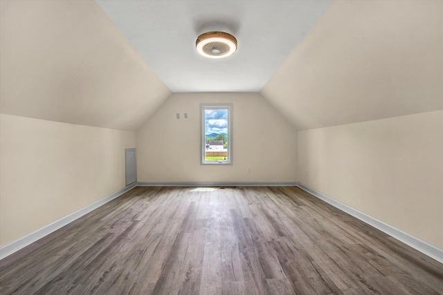 bonus room with hardwood / wood-style floors and lofted ceiling