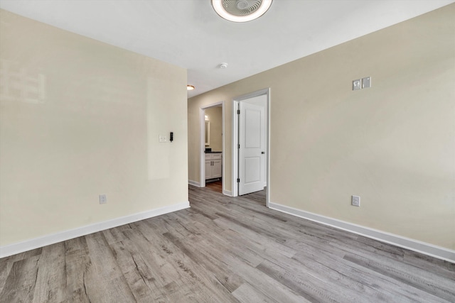 spare room with light hardwood / wood-style flooring