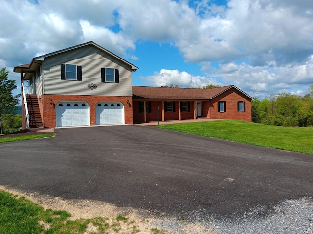 view of front of house featuring a garage and a front lawn