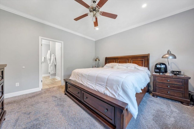 carpeted bedroom featuring ceiling fan, crown molding, and ensuite bath