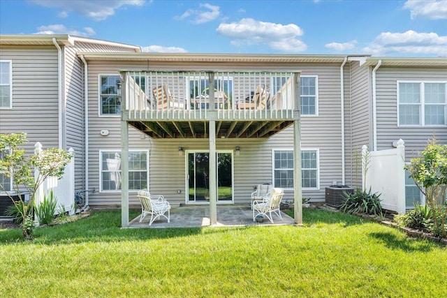 rear view of property featuring a lawn, a patio, and central air condition unit