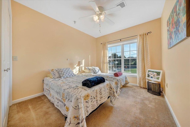 bedroom with ceiling fan and light carpet