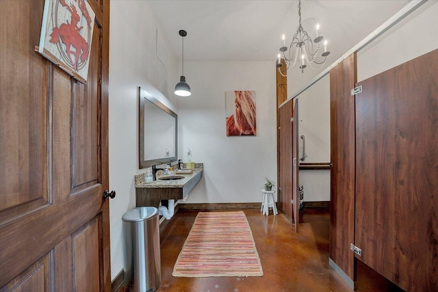 entrance foyer with sink and a chandelier