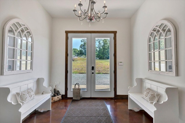 doorway featuring french doors, a wealth of natural light, and an inviting chandelier