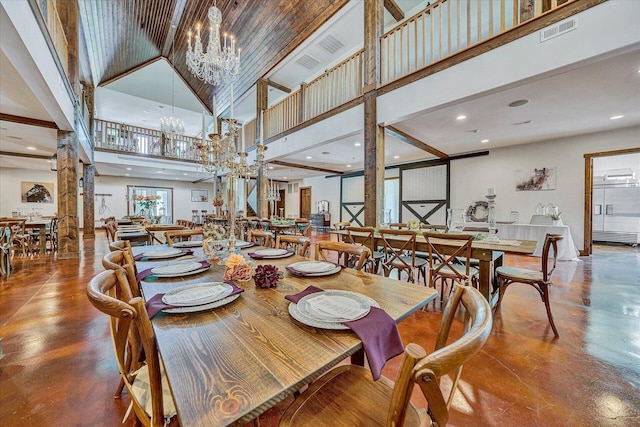 dining area with a high ceiling and an inviting chandelier