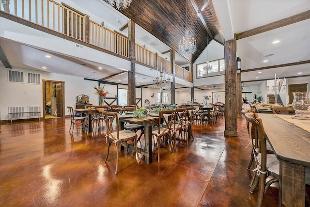 dining space featuring a notable chandelier and high vaulted ceiling