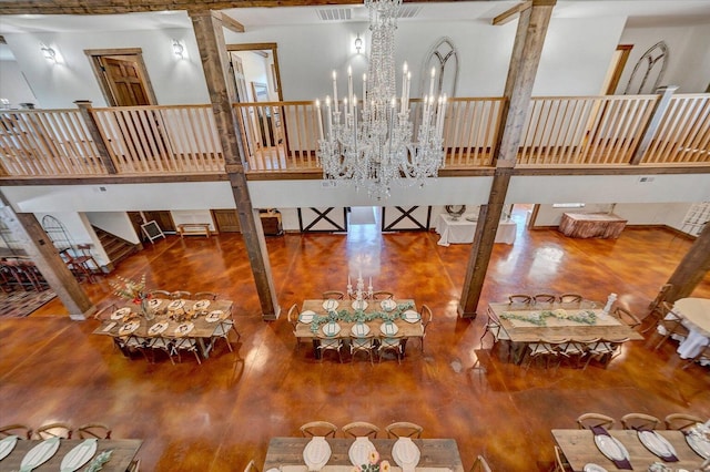 dining space featuring an inviting chandelier, a high ceiling, and wood-type flooring