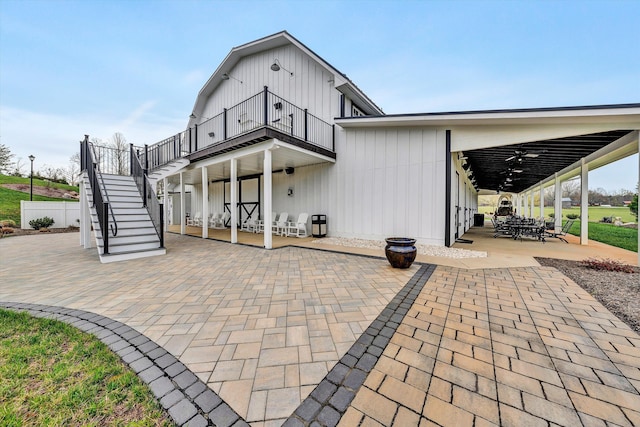 back of house featuring a patio area, fence, and stairway
