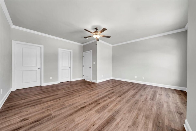 interior space featuring crown molding, ceiling fan, wood finished floors, and baseboards