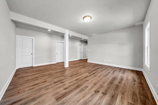 basement featuring baseboards and wood finished floors