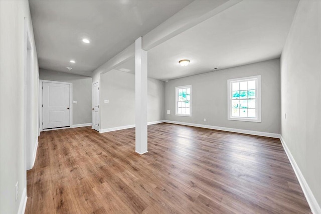 basement featuring recessed lighting, baseboards, and wood finished floors