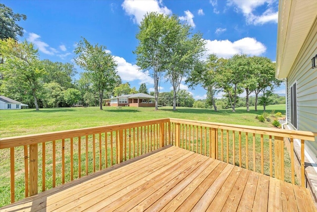 wooden deck featuring a lawn