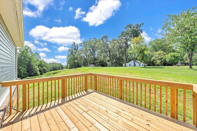 wooden terrace featuring a lawn