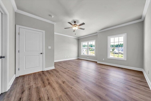 bedroom featuring ceiling fan, ornamental molding, wood finished floors, and baseboards