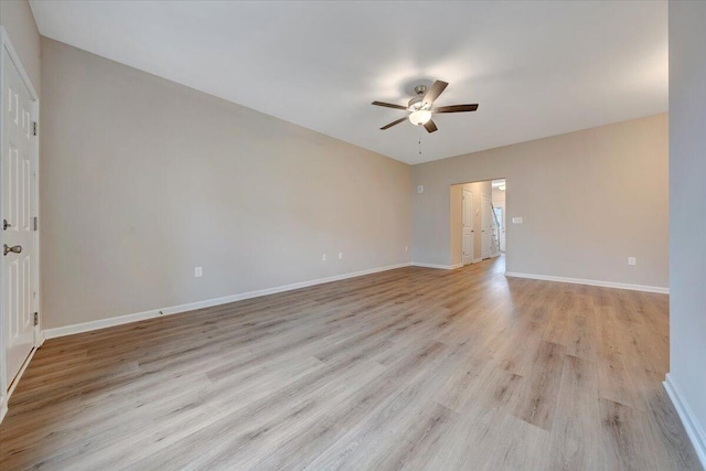 empty room featuring ceiling fan and light hardwood / wood-style flooring