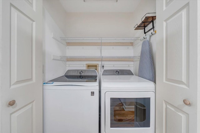 clothes washing area with washing machine and dryer and laundry area