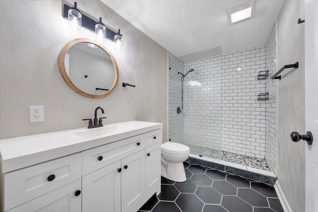 full bath with a stall shower, tile patterned flooring, vanity, and toilet