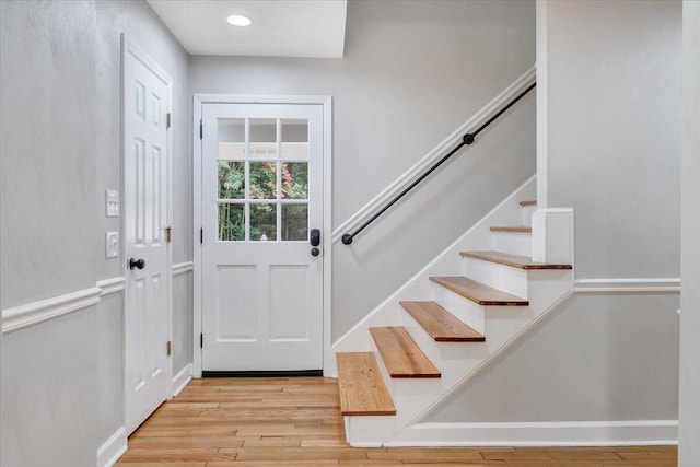 foyer with stairs and light wood-style floors