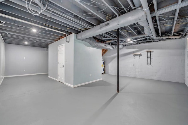 unfinished below grade area featuring visible vents, electric water heater, and baseboards