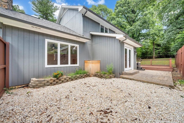 exterior space featuring a chimney, fence, and a patio