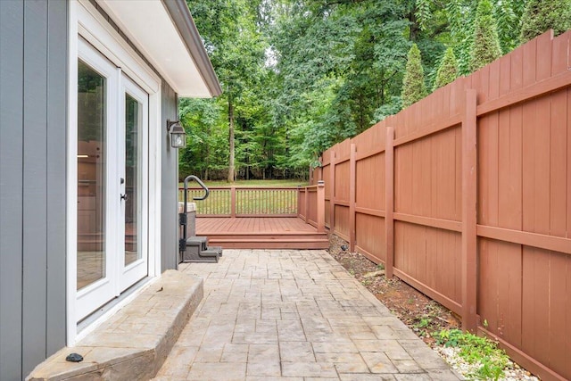 view of patio featuring a deck and a fenced backyard