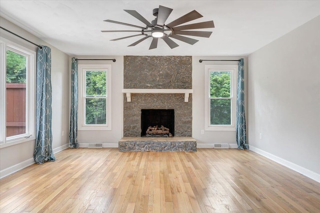 unfurnished living room featuring a wealth of natural light and light wood-type flooring