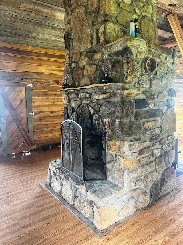 details with hardwood / wood-style floors, a fireplace, and wooden walls