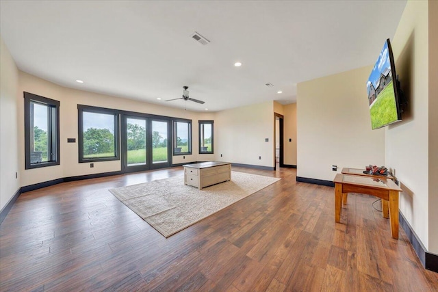 living room featuring ceiling fan, a healthy amount of sunlight, and wood-type flooring