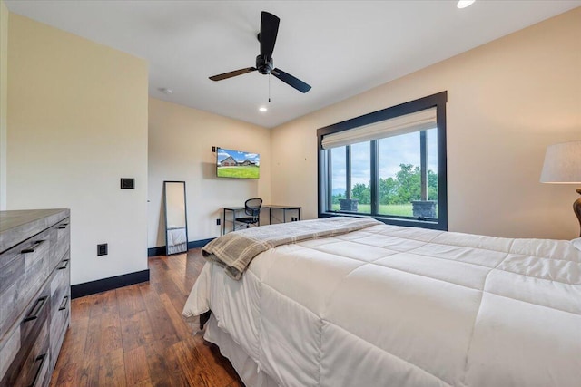 bedroom with ceiling fan and dark hardwood / wood-style flooring