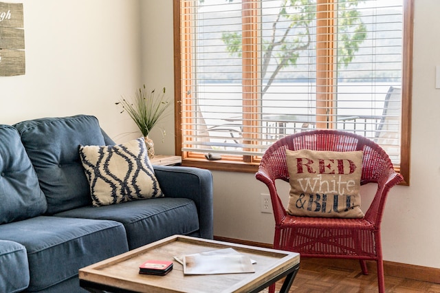 living room featuring plenty of natural light and parquet flooring