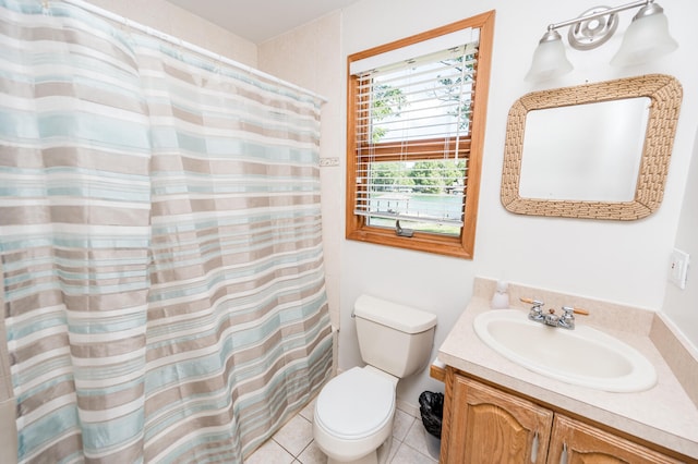 bathroom with tile floors, toilet, and vanity