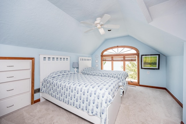 bedroom featuring light carpet, a textured ceiling, lofted ceiling, and ceiling fan