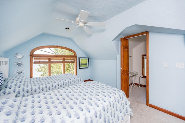 carpeted bedroom with ceiling fan, a textured ceiling, and lofted ceiling