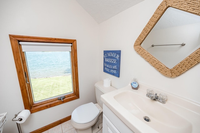 bathroom featuring tile floors, sink, lofted ceiling, and toilet