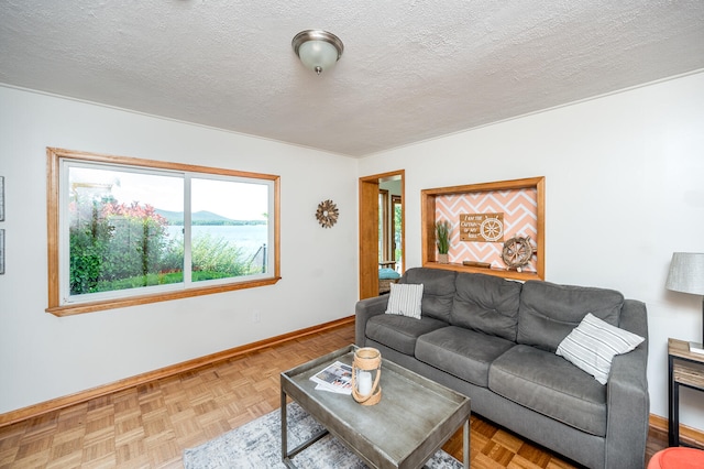 living room with parquet floors and a textured ceiling