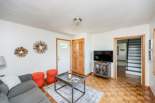 living room with a textured ceiling and light parquet flooring