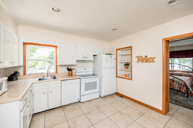 kitchen featuring white cabinetry, a textured ceiling, white appliances, sink, and light tile floors