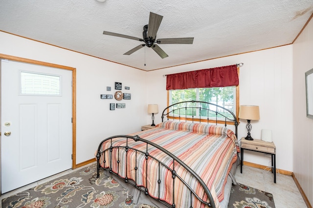 bedroom with ceiling fan and a textured ceiling