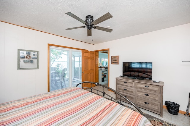 bedroom featuring light tile floors, access to exterior, ceiling fan, and a textured ceiling