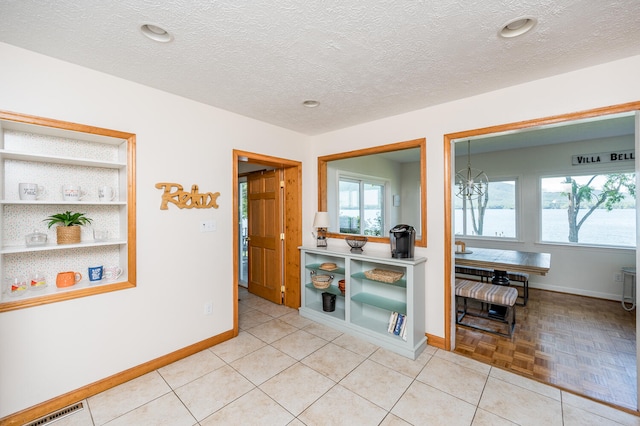 interior space with light tile flooring and a textured ceiling