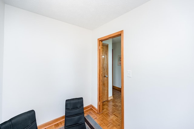 interior space featuring parquet floors and a textured ceiling