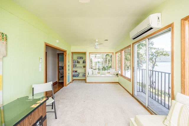 sunroom featuring ceiling fan, vaulted ceiling, and an AC wall unit