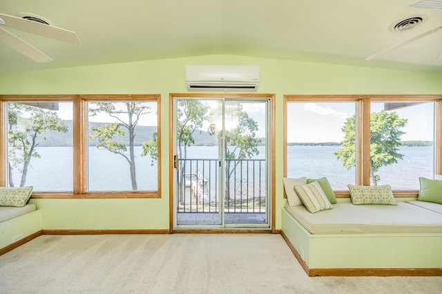 unfurnished sunroom featuring a healthy amount of sunlight, vaulted ceiling, and an AC wall unit