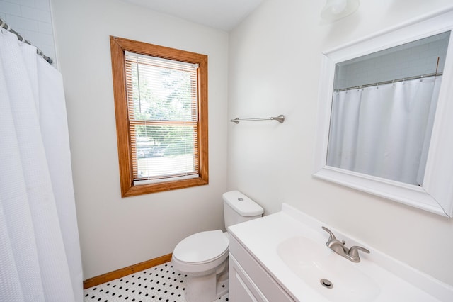 bathroom featuring tile floors, oversized vanity, and toilet