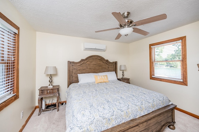 bedroom with light carpet, ceiling fan, and a textured ceiling