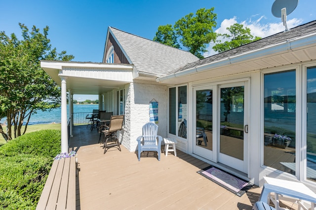 wooden deck featuring a water view