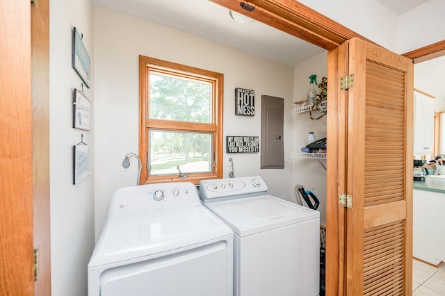 washroom featuring washer and dryer and light tile floors