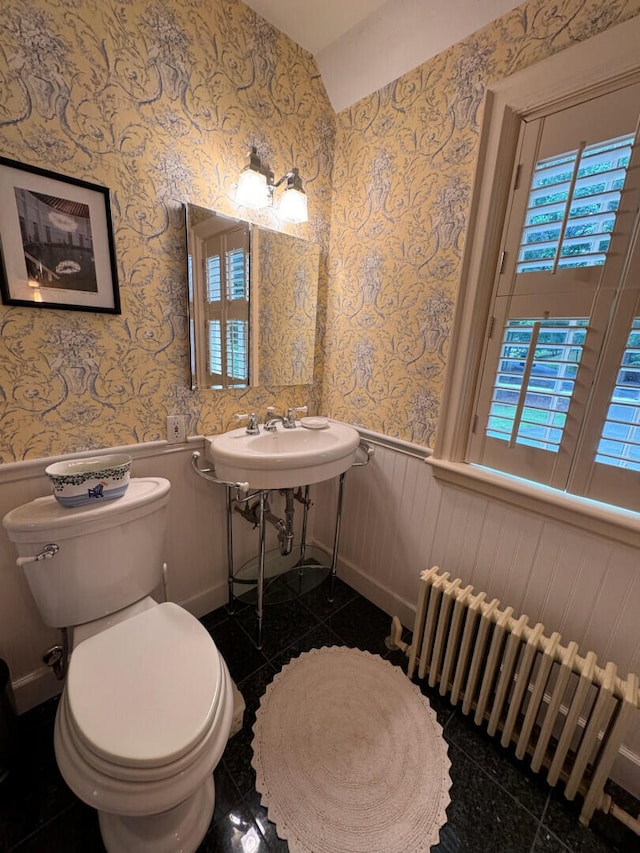 bathroom featuring tile patterned floors, toilet, and radiator heating unit